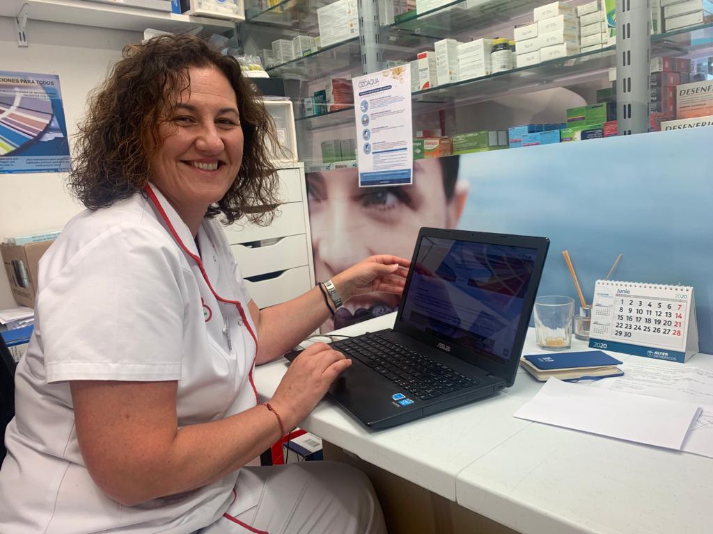 Farmacéutica comunitaria en su farmacia durante la atención y el seguimiento de pacientes con tratamiento crónico.