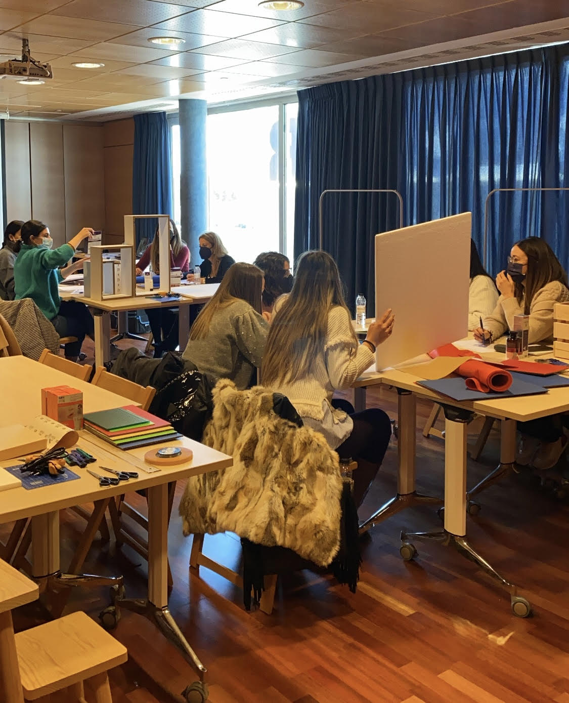 Farmacéuticos participantes en el taller presencial de escaparatismo de Novaltia, trabajando en grupo en el diseño y montaje de escaparates durante una sesión práctica.